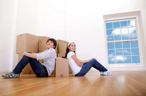 Professional movers carrying items through a Palmersgreen property