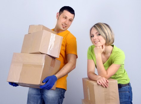 Professional movers carrying furniture during a Palmers Green house move