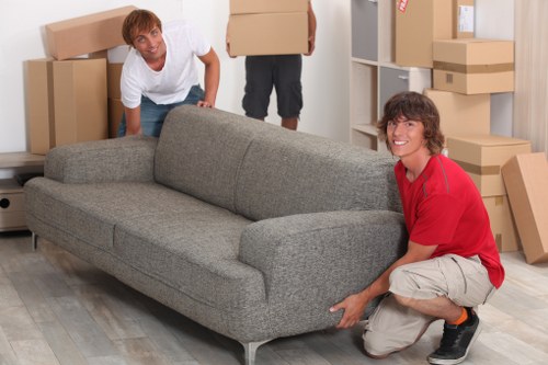 Professional movers handling desks and IT equipment during relocation